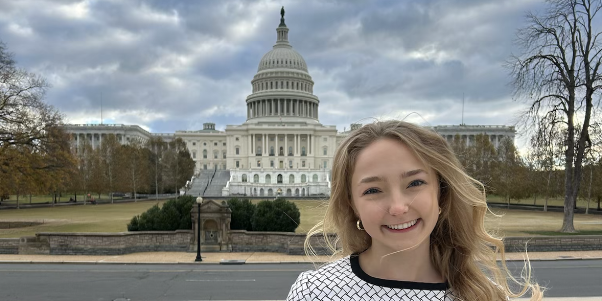 JRS/USA Intern, Alie, advocating on behalf of refugees standing in front of the U.S. Capitol Building.